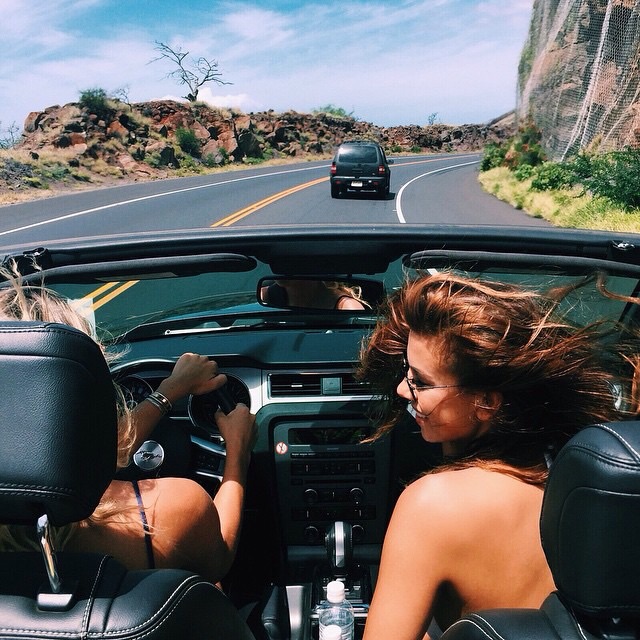the blonde and the brunette in the car on the road