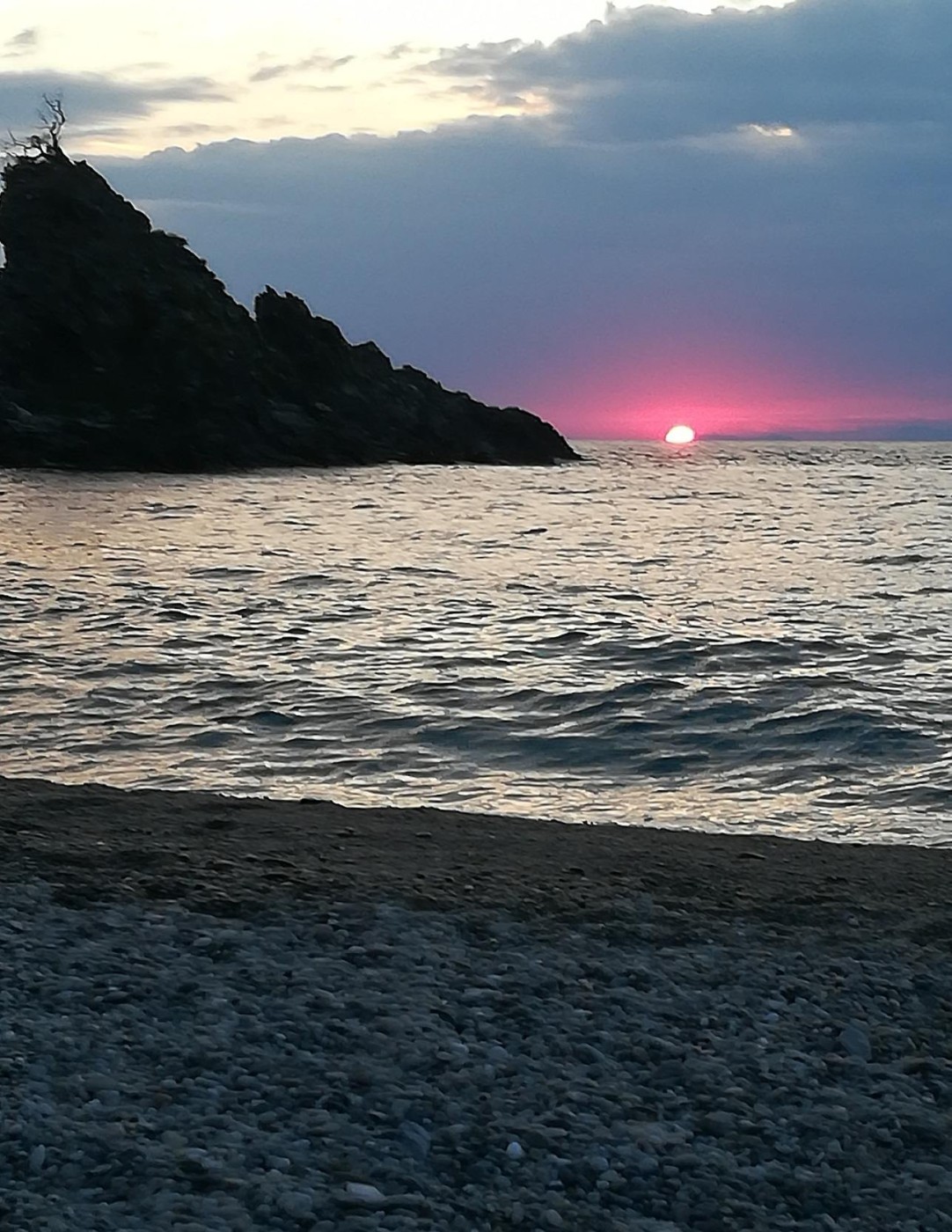 insieme allo scoglio dell’Olivarella, osserviamo il Sole calare